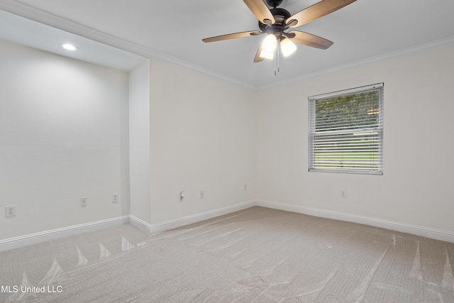 empty room featuring ceiling fan, carpet floors, and ornamental molding