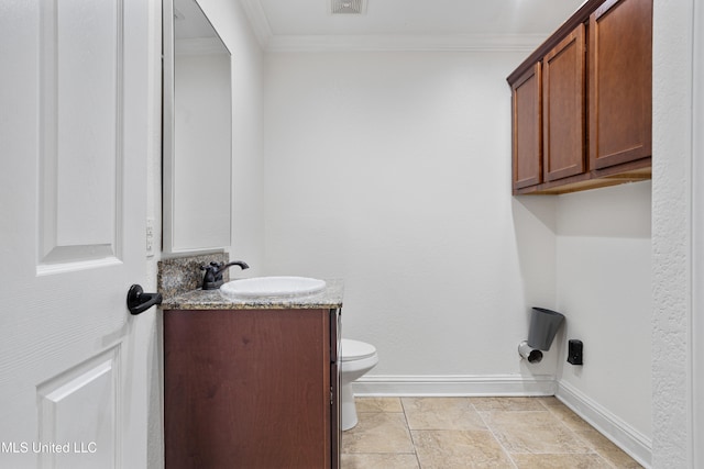 bathroom with vanity, toilet, and crown molding