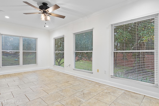 unfurnished room with ceiling fan and ornamental molding