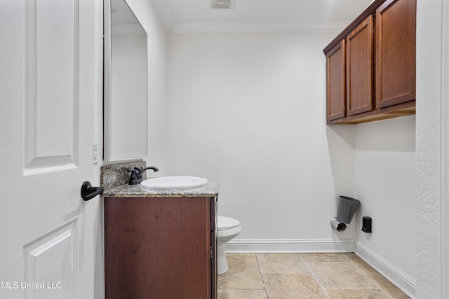 13901 Plano Rd, Ocean Springs, MS 39564 - half bath with crown molding, baseboards, vanity, toilet, and stone finish floors