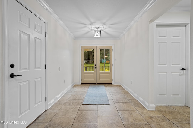 entryway with ornamental molding and french doors