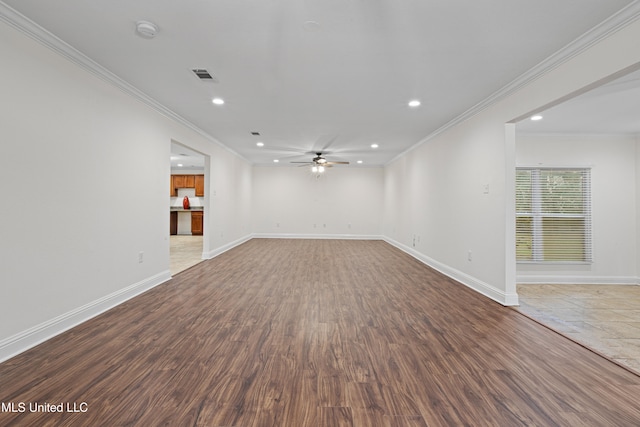 spare room with ceiling fan, ornamental molding, and hardwood / wood-style flooring