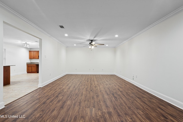 spare room featuring light hardwood / wood-style flooring, ceiling fan, and ornamental molding