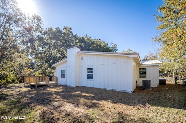 back of house featuring a wooden deck and cooling unit