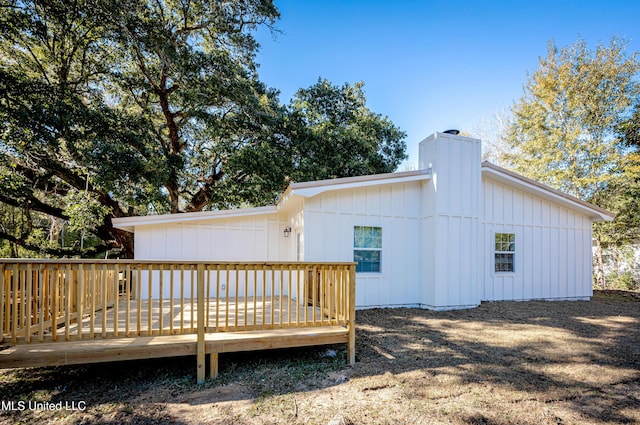 rear view of property featuring a wooden deck