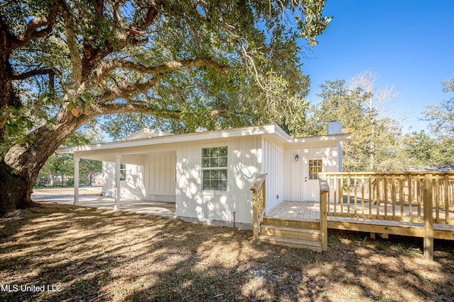 rear view of house featuring a deck and a patio area