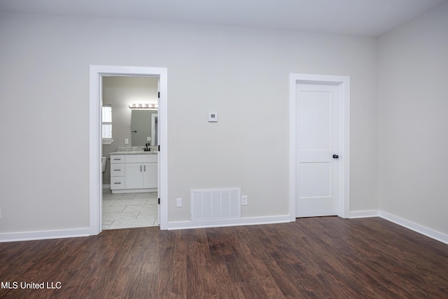 empty room featuring dark hardwood / wood-style flooring and sink