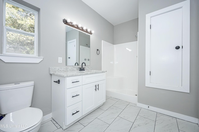 bathroom with vanity, toilet, and walk in shower