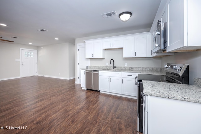 kitchen featuring sink, stainless steel appliances, light stone counters, dark hardwood / wood-style floors, and white cabinets