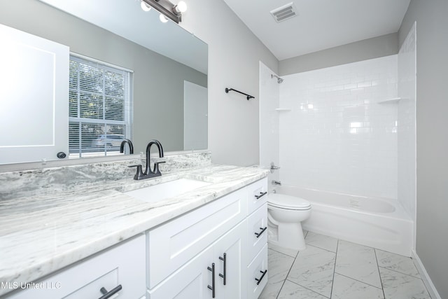 full bathroom with vanity, tiled shower / bath, and toilet