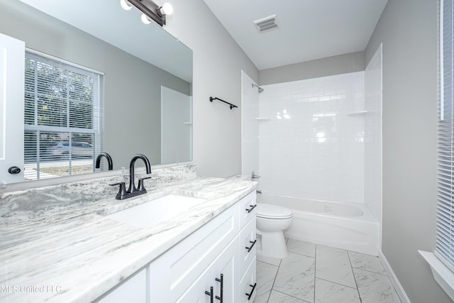 full bathroom featuring tiled shower / bath combo, a wealth of natural light, toilet, and vanity