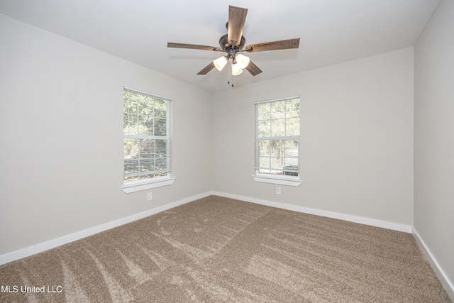 carpeted empty room featuring ceiling fan