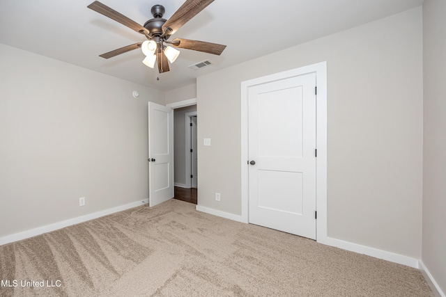 unfurnished bedroom with ceiling fan and light carpet