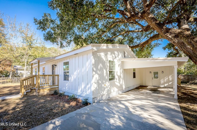 view of side of property with a carport