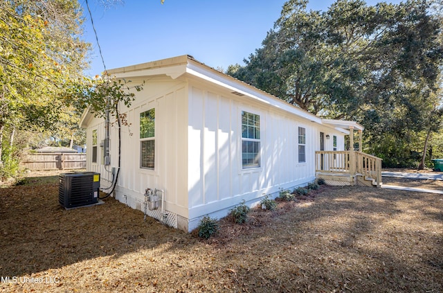 view of side of home with central air condition unit