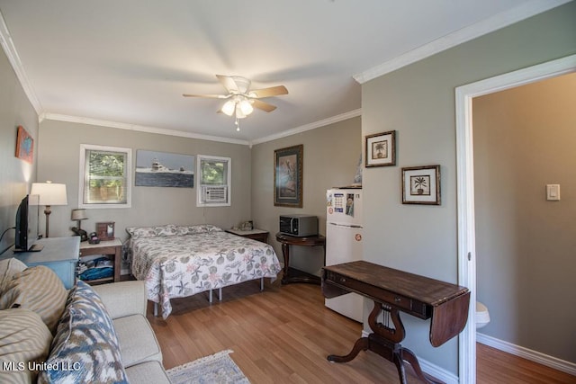 bedroom with hardwood / wood-style flooring, ornamental molding, white refrigerator, and ceiling fan