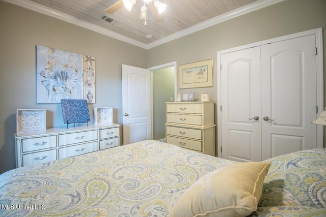 bedroom with ornamental molding, wooden ceiling, ceiling fan, and a closet