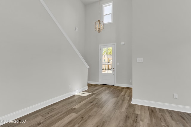 10262 March Meadows Way, Olive Branch, MS 38654 - entryway featuring a chandelier, wood finished floors, baseboards, and a towering ceiling