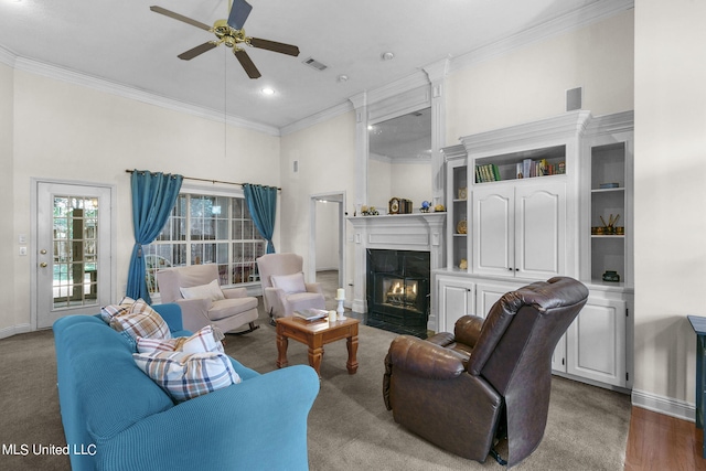 living room with crown molding, wood-type flooring, a towering ceiling, and ceiling fan