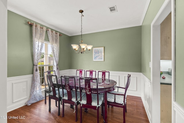 dining space with a chandelier, crown molding, and dark hardwood / wood-style flooring