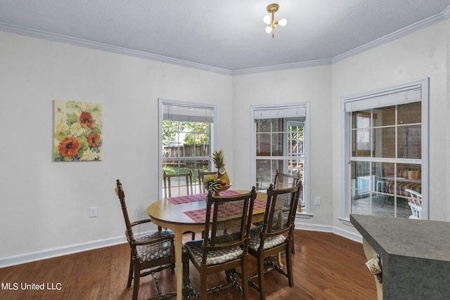 dining room with crown molding and dark hardwood / wood-style flooring