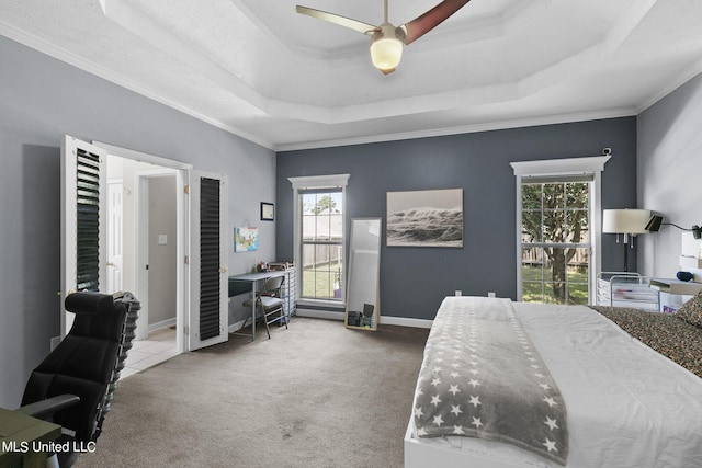 bedroom with crown molding, carpet flooring, a raised ceiling, and ceiling fan