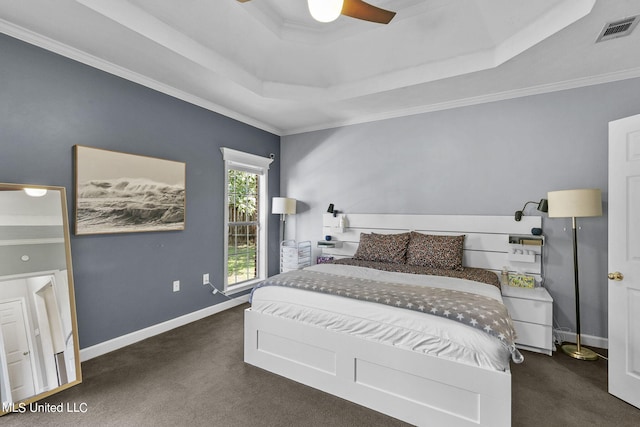 carpeted bedroom featuring ornamental molding, a raised ceiling, and ceiling fan