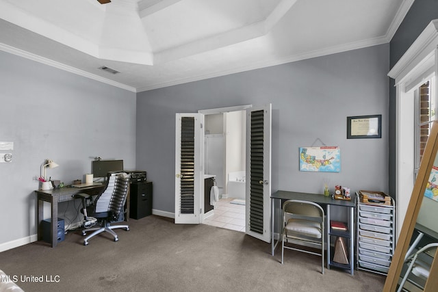 carpeted home office featuring crown molding and a raised ceiling