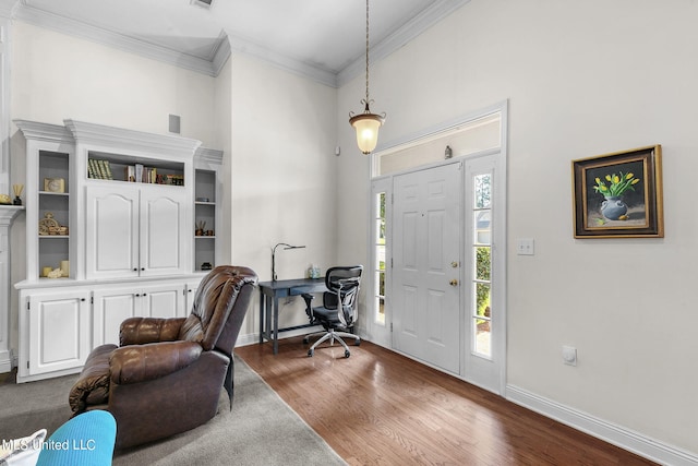 entrance foyer with ornamental molding and dark hardwood / wood-style flooring