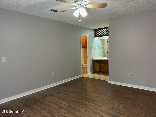 1613 Springridge Dr, Jackson, MS 39211 - unfurnished bedroom with dark wood-type flooring, a textured ceiling, baseboards, and ensuite bathroom