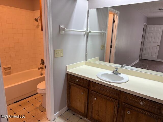 1613 Springridge Dr, Jackson, MS 39211 - full bath featuring vanity, toilet, baseboards, and bathtub / shower combination