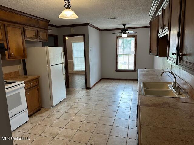1613 Springridge Dr, Jackson, MS 39211 - kitchen featuring white appliances, a sink, a ceiling fan, crown molding, and a textured ceiling