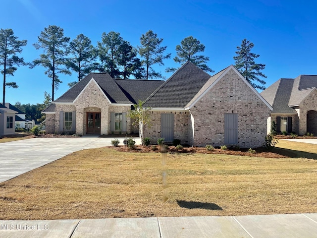 352 Wellstone Pl, Madison, MS 39110 - french country inspired facade with brick siding, a front lawn, and driveway