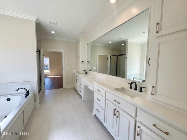 bathroom featuring vanity, crown molding, shower with separate bathtub, and tile patterned floors