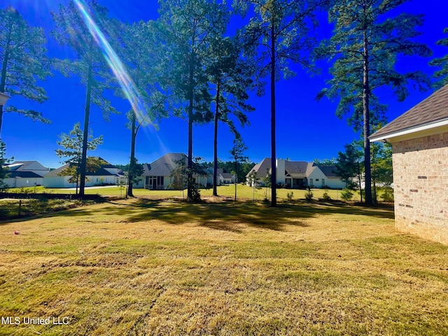 352 Wellstone Pl, Madison, MS 39110 - view of green lawn featuring a residential view
