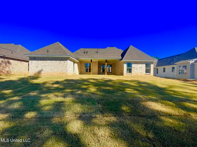 back of house featuring a yard