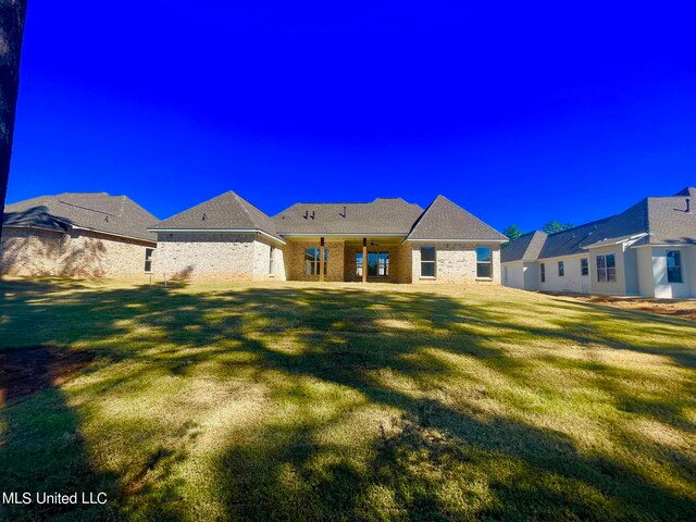 rear view of house with a lawn