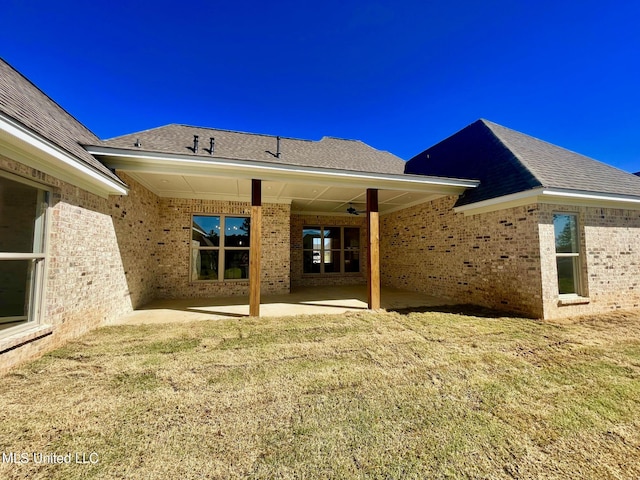 352 Wellstone Pl, Madison, MS 39110 - back of property with brick siding, a patio area, and a yard