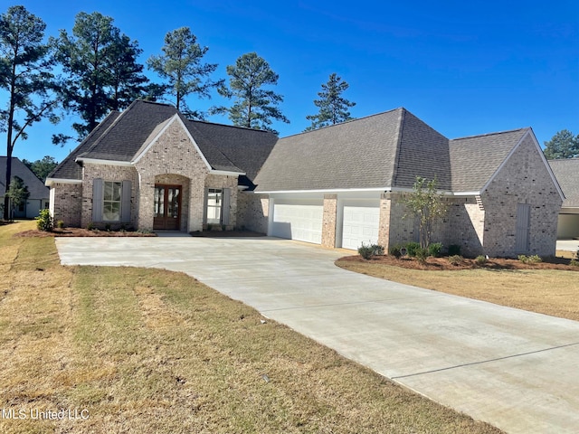 view of front facade with a front lawn and a garage