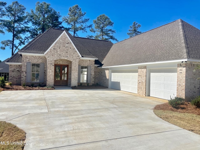 view of front of home with french doors and a garage