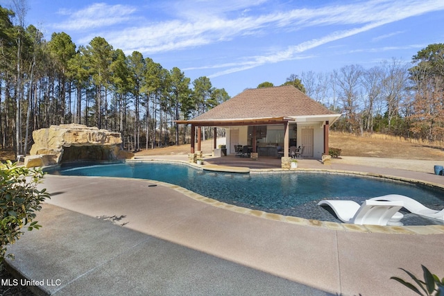 view of pool featuring an outbuilding and a patio area