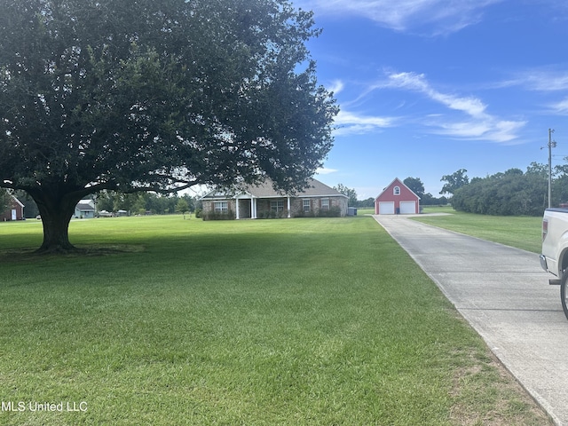 8101 Pecan Ridge Dr, Moss Point, MS 39562 - view of front of home with a garage, an outdoor structure, and a front yard