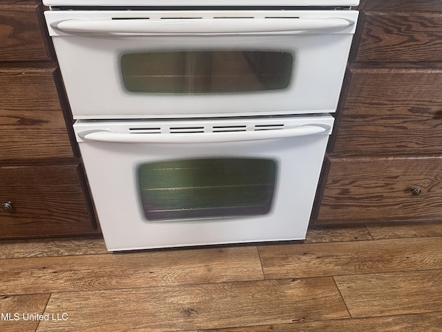 8101 Pecan Ridge Dr, Moss Point, MS 39562 - kitchen view of double oven, wood finished floors, and dark brown cabinets