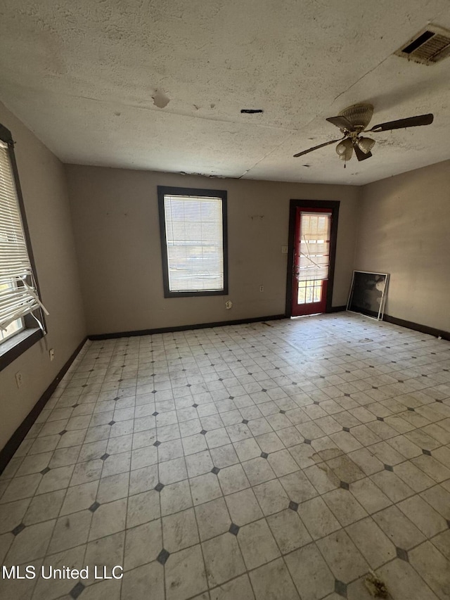 spare room featuring ceiling fan and a textured ceiling