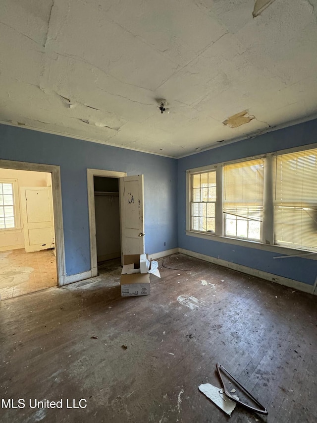 unfurnished bedroom featuring multiple windows