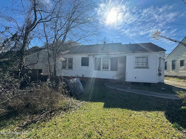 rear view of house with a lawn