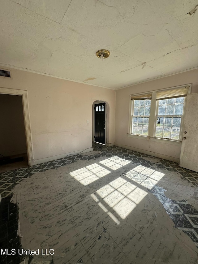 spare room with a textured ceiling