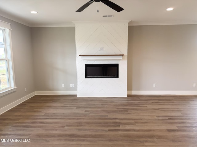 unfurnished living room featuring ornamental molding, a ceiling fan, plenty of natural light, and visible vents