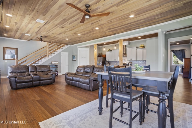 dining area with ornamental molding, a ceiling fan, hardwood / wood-style flooring, stairway, and wooden ceiling