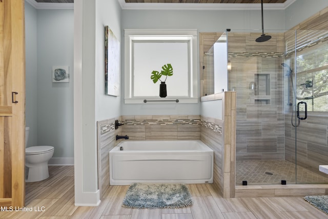 bathroom featuring a garden tub, baseboards, toilet, and a shower stall